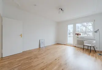 Wohnzimmer mit Balkontür, Parkett und Stuckdecke